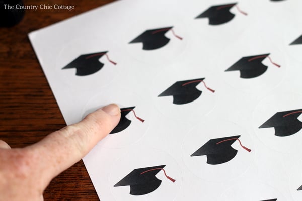 applying oil to graduation hat stickers