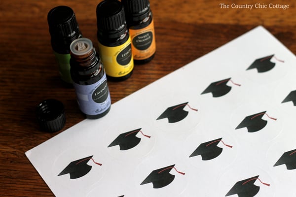 bottles of essential oils and graduation hat stickers