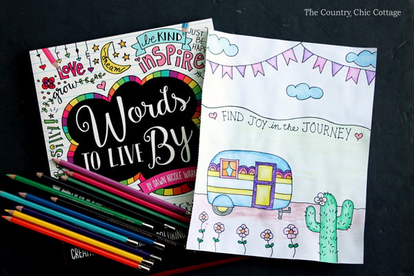 a coloring notebook with watercolor pencils