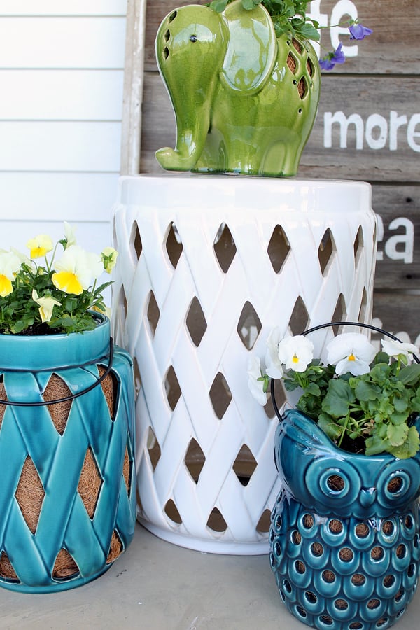 white ceramic stool used as a side table for plants