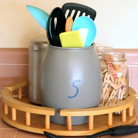 Paint this farmhouse utensil holder with just a crock from the thrift store and a few paints!