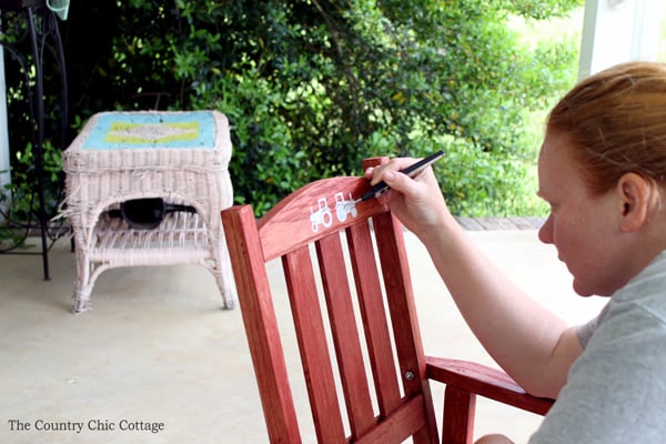 painting white stencil on rocking chair