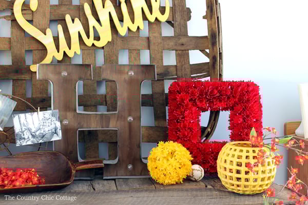 red and yellow flowers on farmhouse style mantel