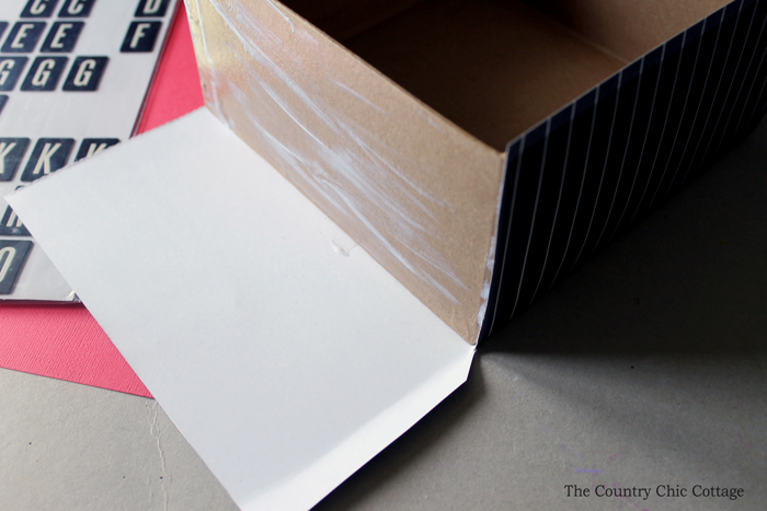 use mod podge to decorate a simple cardboard box 