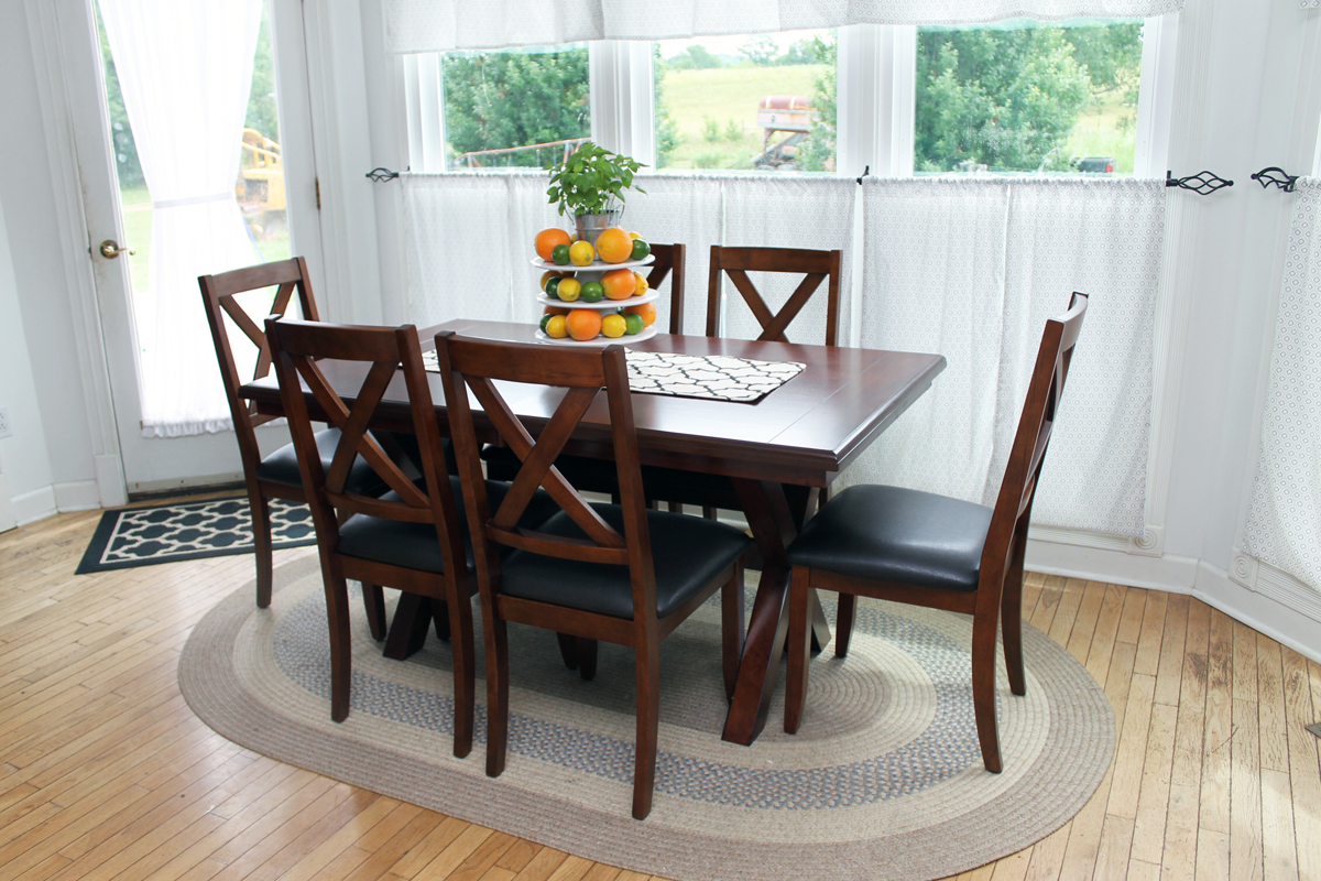 dark table and chairs in a farm kitchen