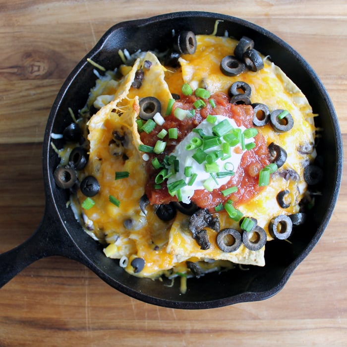 Campfire nachos are a tasty combination of tortilla chips covered in cheese and all your favorite nacho toppings