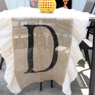 Make this DIY burlap table runner with monogram for your home! I love the simple ruffles on the side as well!