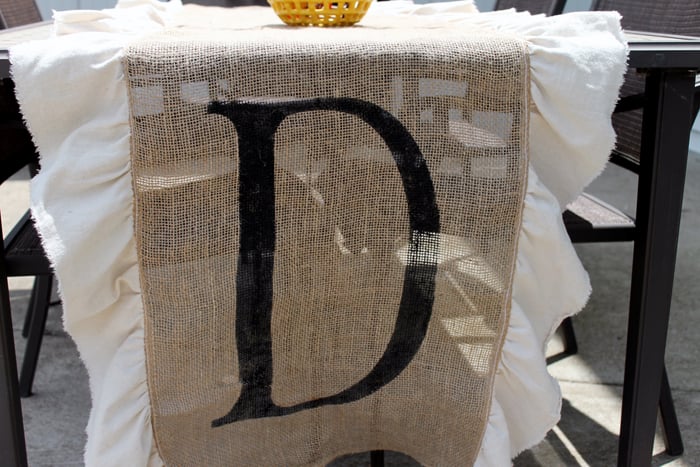 burlap table runner with white ruffles and monogram