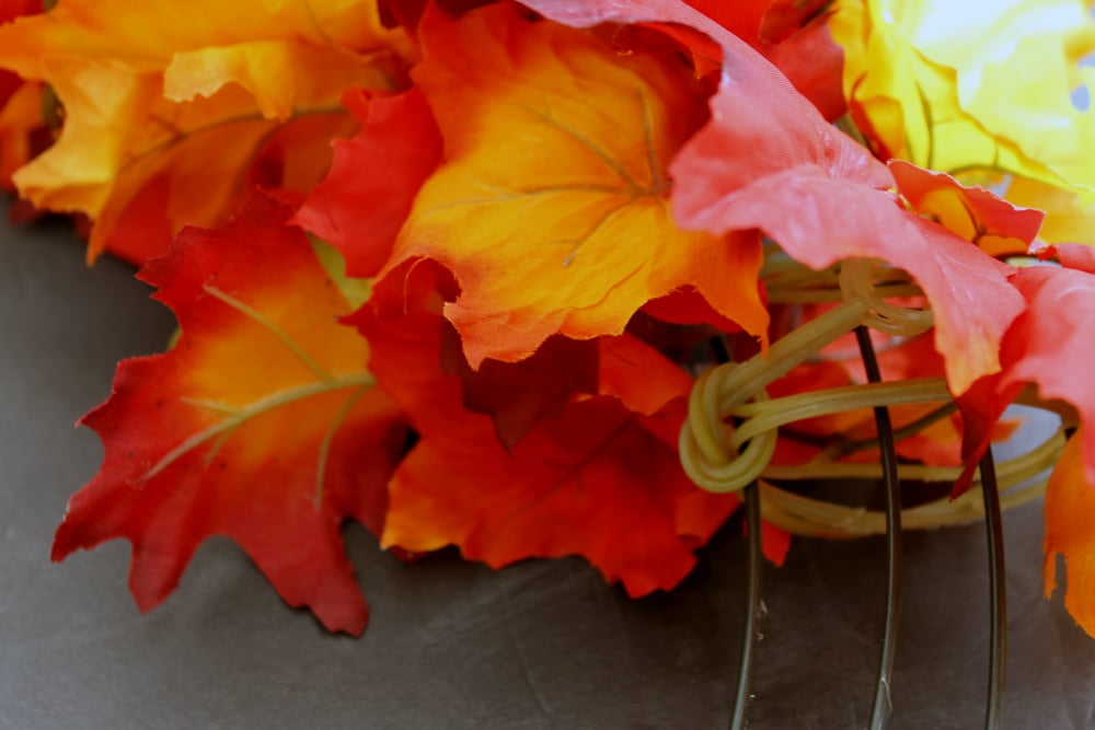 adding fall garlands to a wreath form