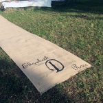 burlap aisle runner in grass