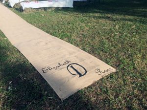 burlap aisle runner in grass