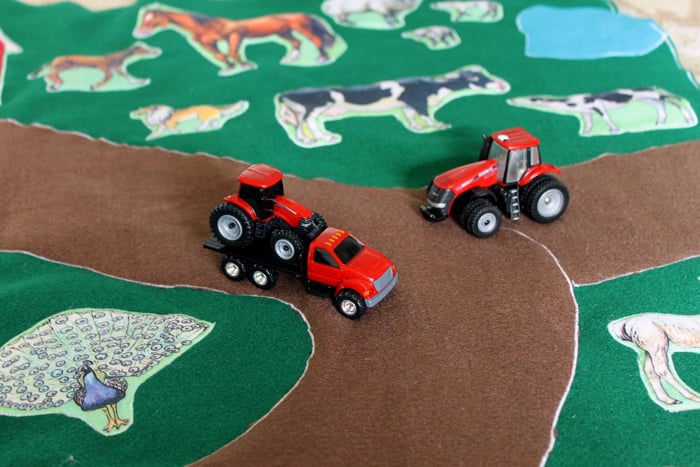 Toy tractors on DIY farm playmat
