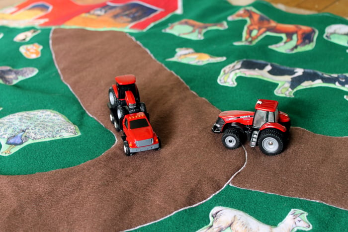 toy tractors on finished play mat