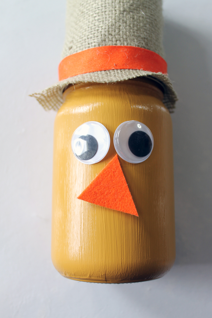 Make this scarecrow jar fall craft idea for your autumn home! A fun craft that the kids will love to help with!
