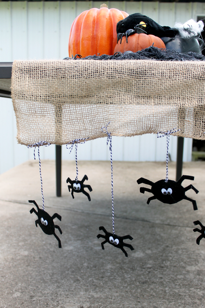 completed Halloween table runner with felt spiders hanging down