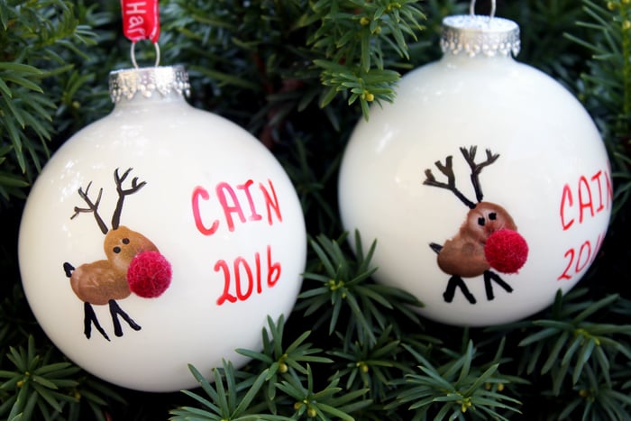 2 reindeer fingerprint ornaments with children's names.