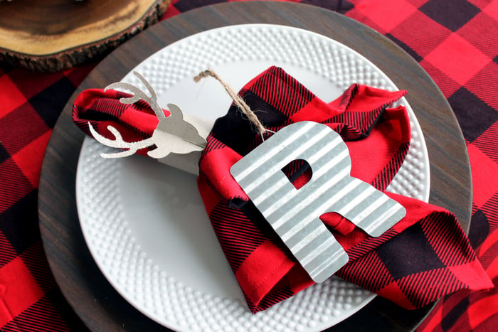 plaid napkins on white plates with letter R ornament 