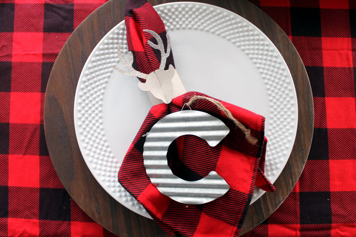 plaid napkins on white plates with letter C ornament 