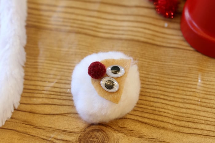 making a santa head from a pom pom