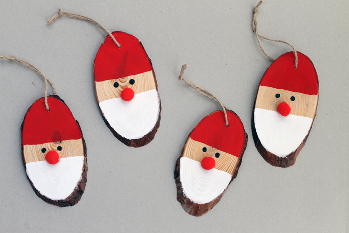 4 Santa DIY wooden ornaments on a table