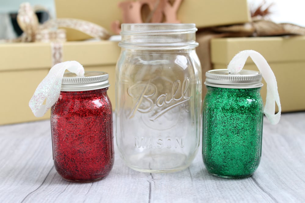red and green pint sized glitter ornaments with large ball mason jar in center