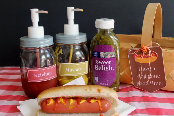Ketchup, Mustard, and Sweet Relish behind a hot dog