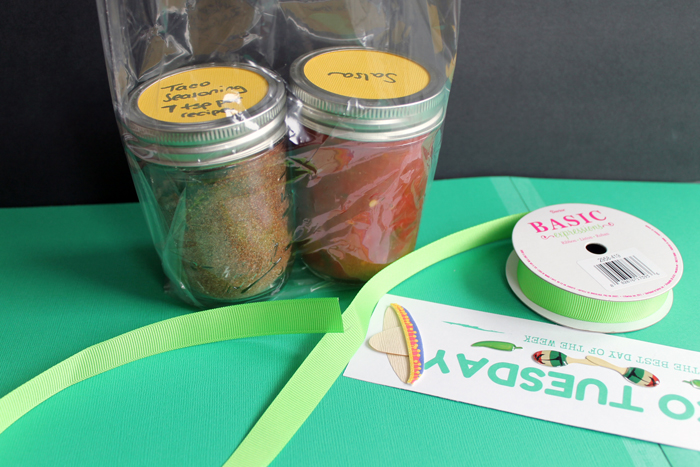 assembling a taco starter kit in a jar gift bag