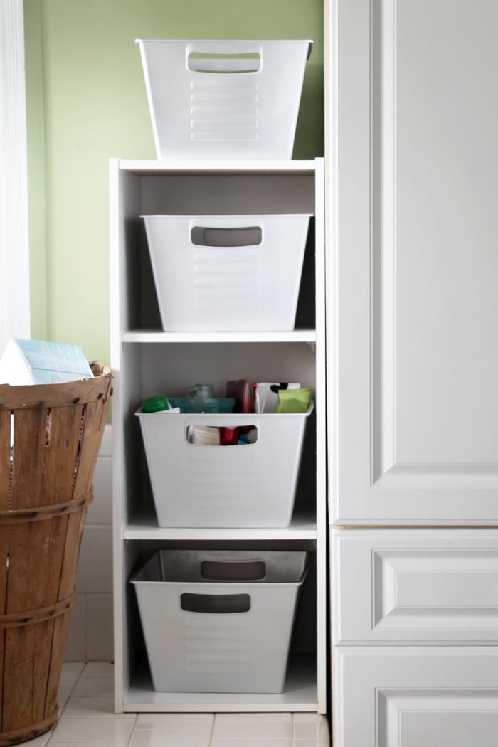 white storage containers in bookshelf