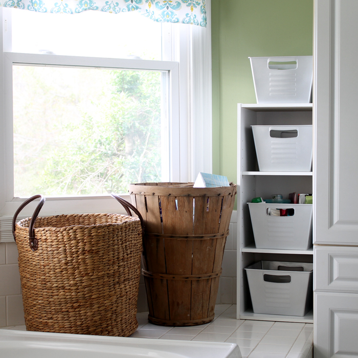 bookshelf of containers with two woven hampers