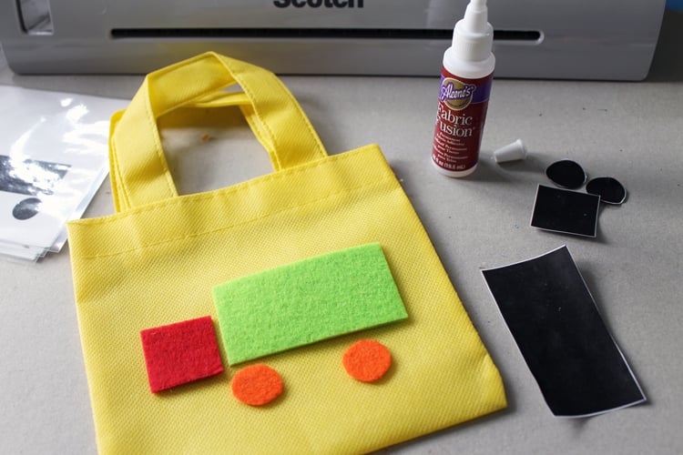 adding cut felt shapes to decorate the carry bag