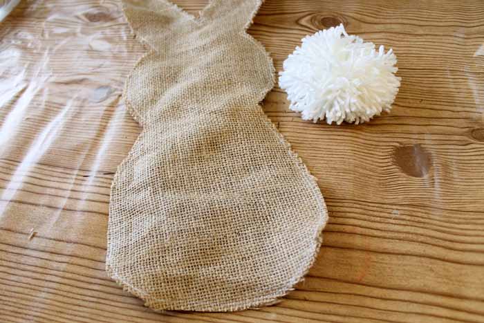 bunny shaped burlap cut out with white yarn pom pom