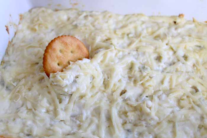 Make this cheesy artichoke dip recipe for any party! The perfect appetizer for a crowd!