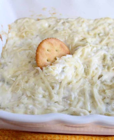 Make this cheesy artichoke dip recipe for any party! The perfect appetizer for a crowd!