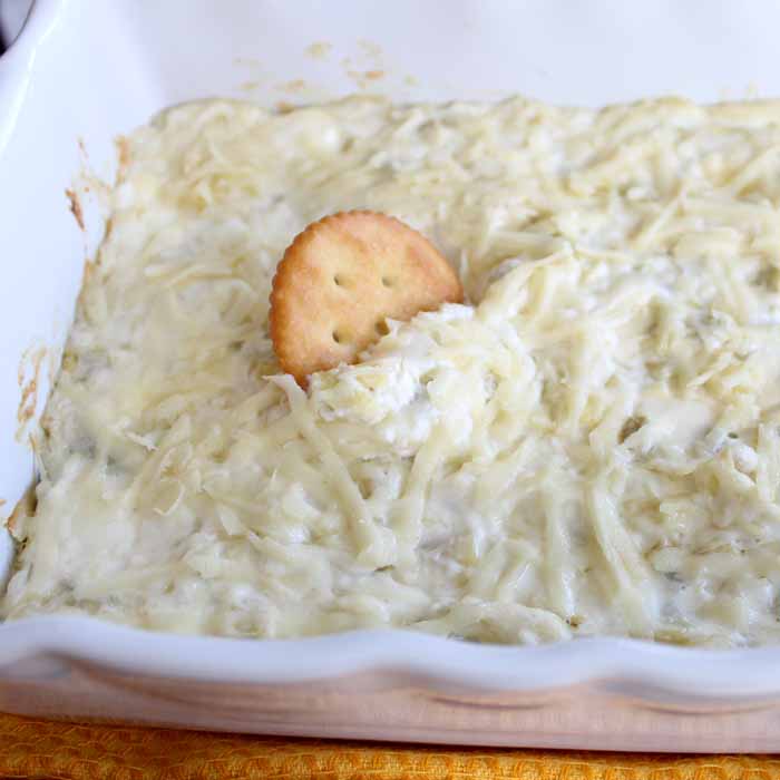 Make this cheesy artichoke dip recipe for any party! The perfect appetizer for a crowd!