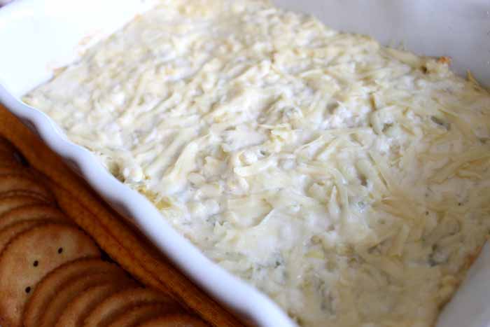 Make this cheesy artichoke dip recipe for any party! The perfect appetizer for a crowd!