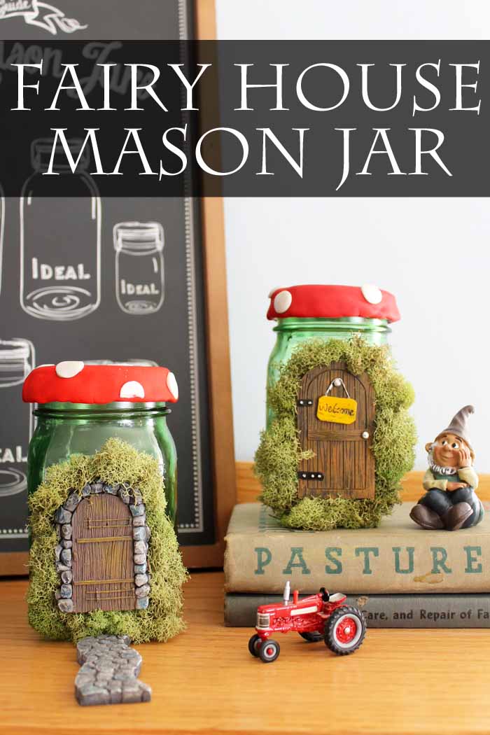 fairy mason jar homes on top of books, with a gnome sitting next to one. There is a toy tractor next to one. 