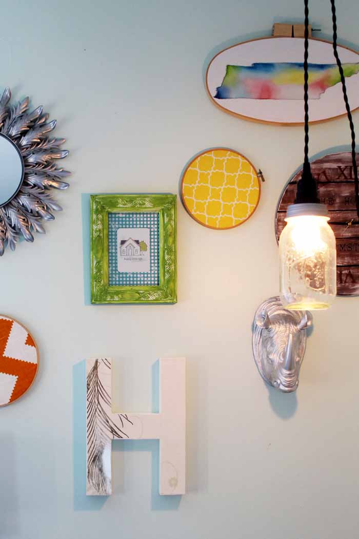 mason jar lights hanging next to wall decor