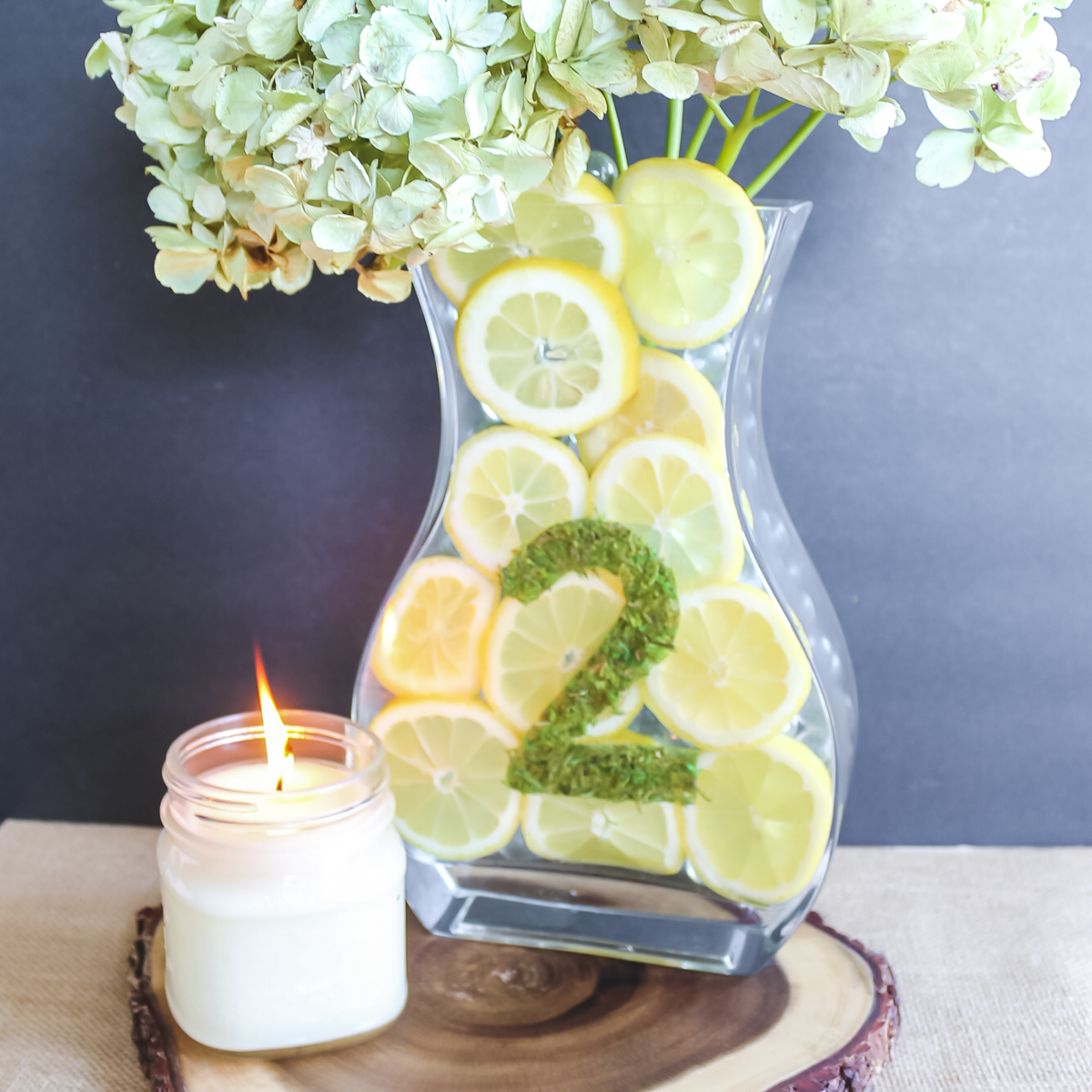 lemon centerpiece on a rustic wood slice