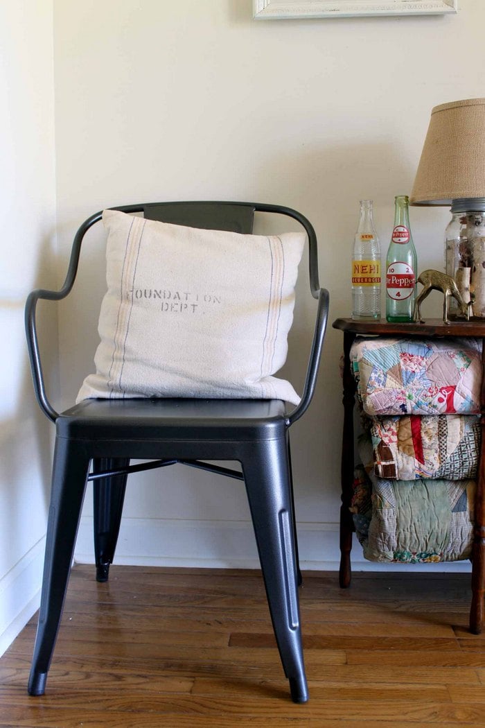 metal chair with a pillow made from a grain sack