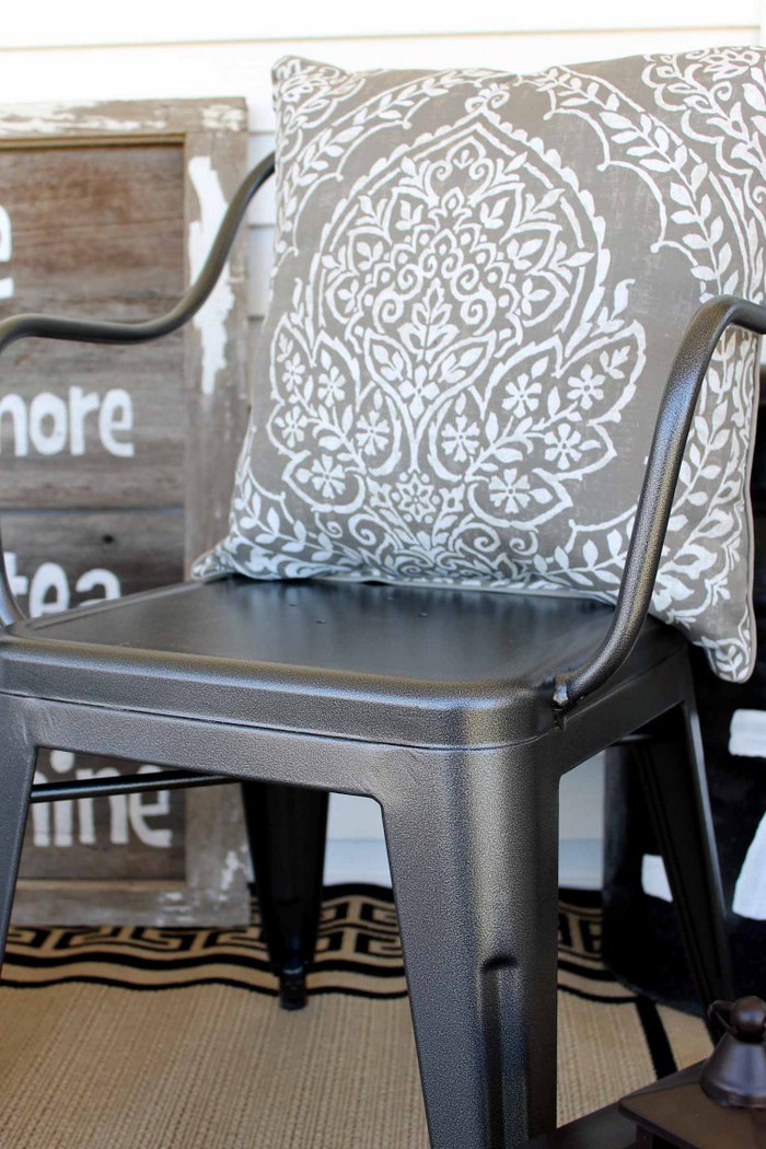 close up of arm on a farmhouse metal chair