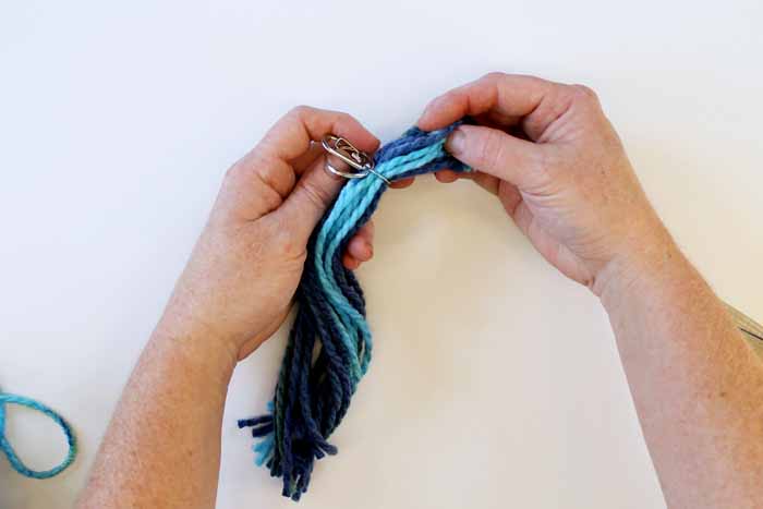 pulling the keyring to the middle of the yarn