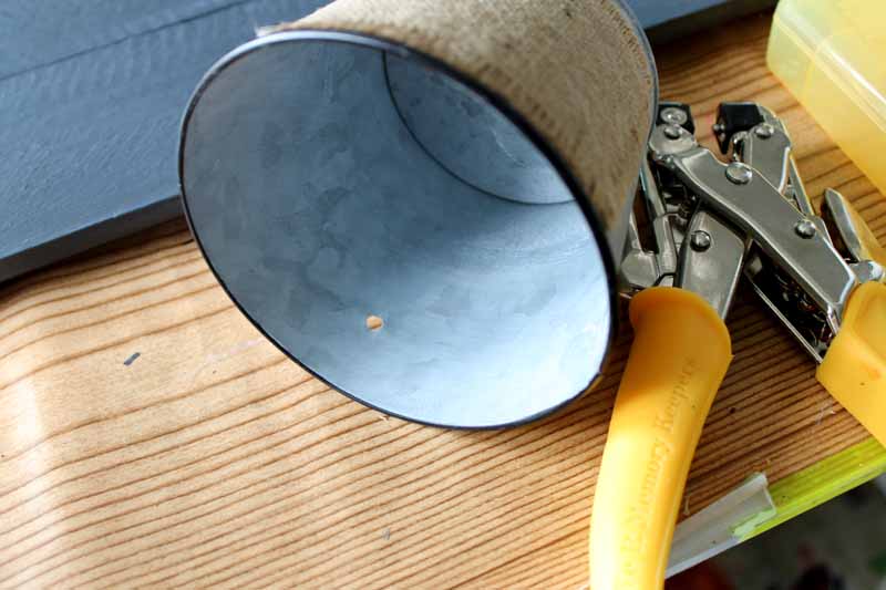 DIY Garden Tool Storage one bucket with hole puncher on wood