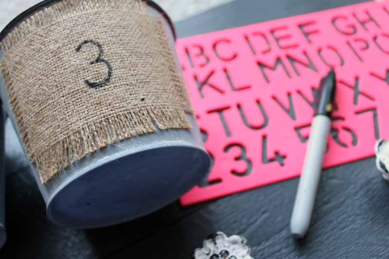 DIY Garden Tool Storage bucket with number 3 next to marker and stencil