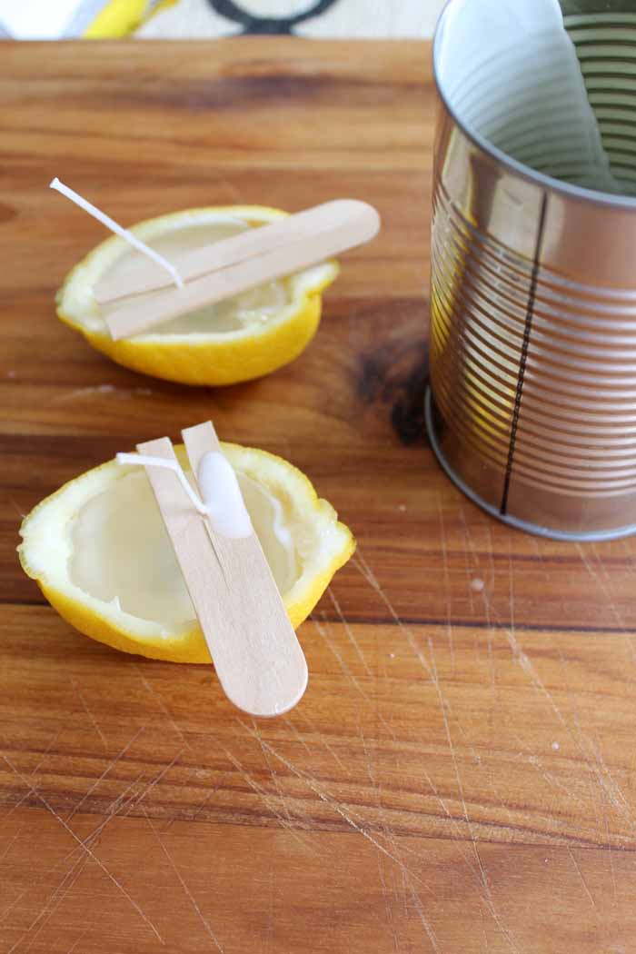 pouring wax into lemon halves to make candles