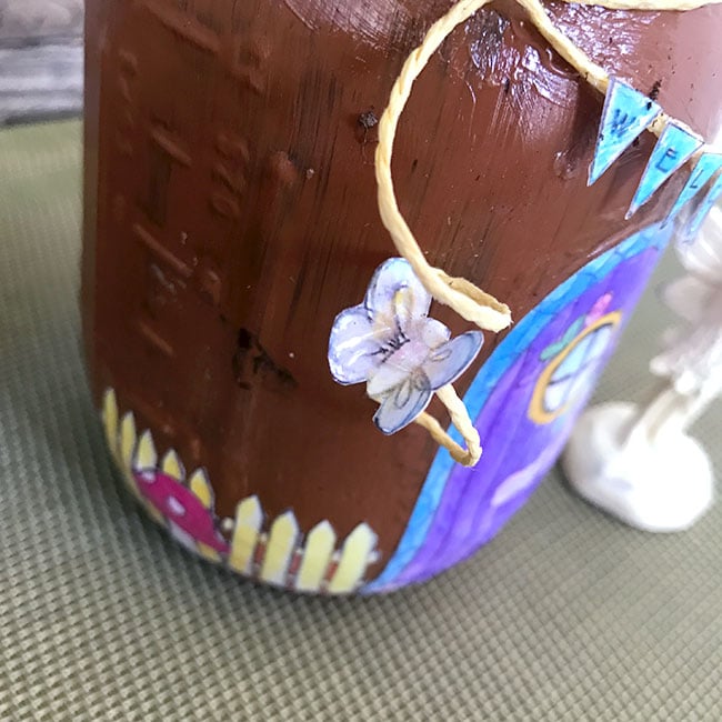 Use mod podge to attach fun little details to your mason jar fairy home