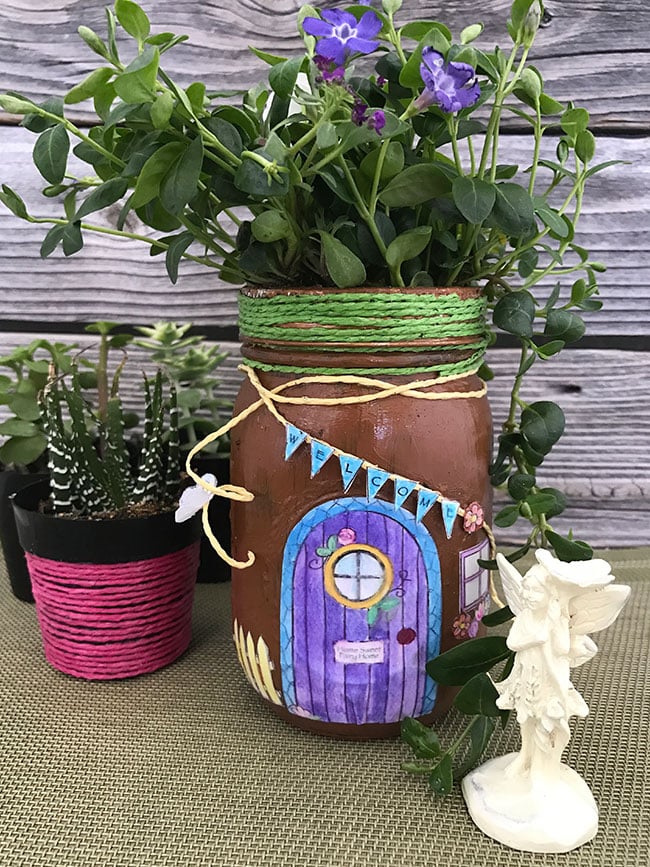 Make this mason jar fairy house this spring! Great free printable fairy garden coloring page as well!