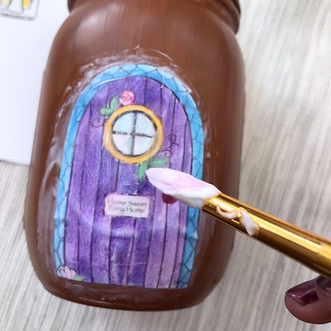Attach the coloring page to the mason jar with mod podge