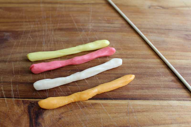 long thing strands of fruit chew candy on wooden countertop