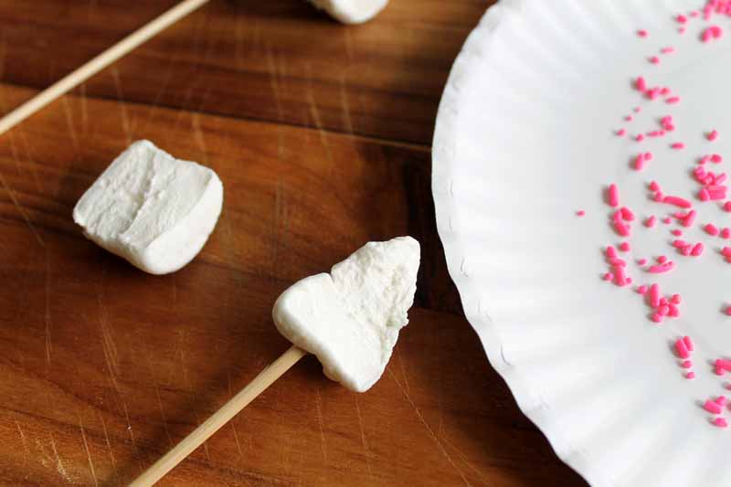 closeup shot of sliced marshmallow in ear shape attached to wooden skewer