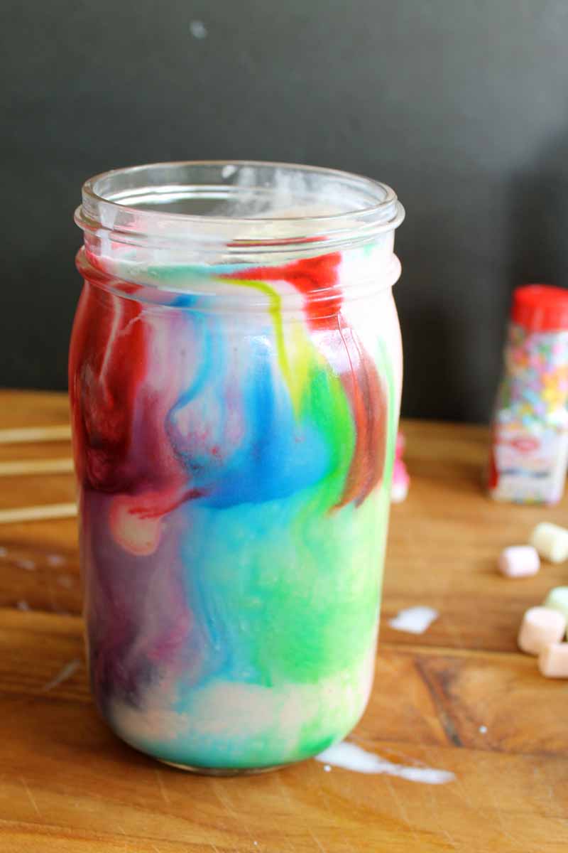 close up shot of colorful unicorn drink in mason jar